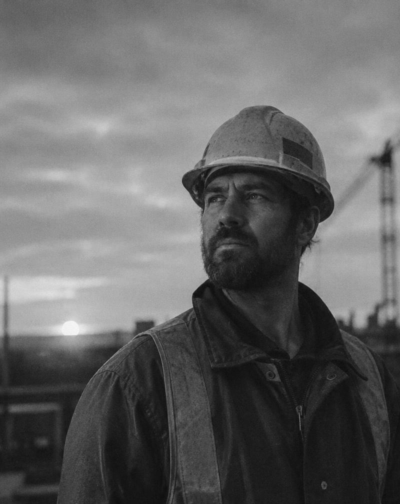 Construction worker in a hard hat at dawn
