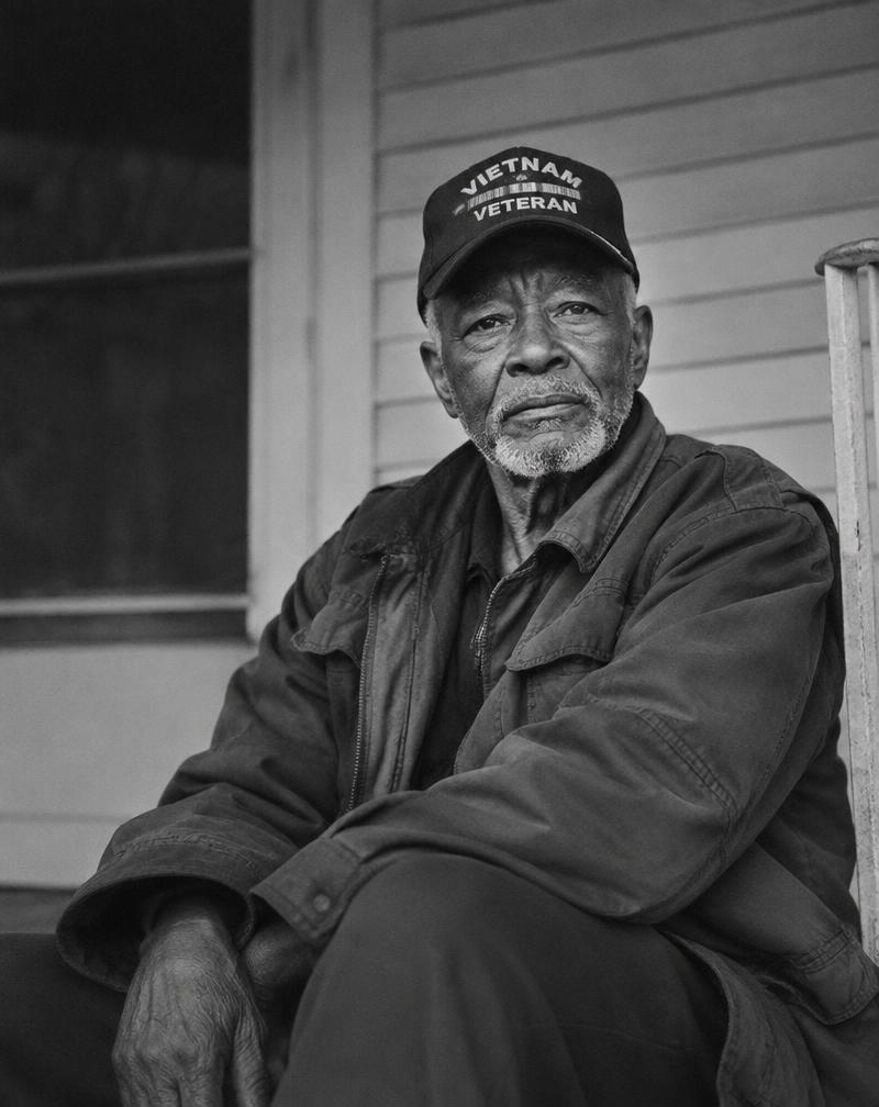 Portrait of an older veteran sitting on his porch